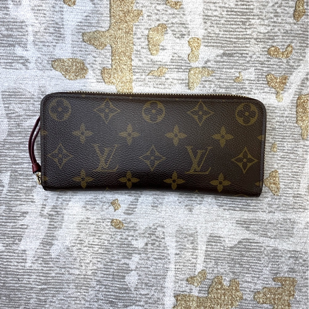 Louis Vuitton Clemence monogram wallet with fuschia interior.